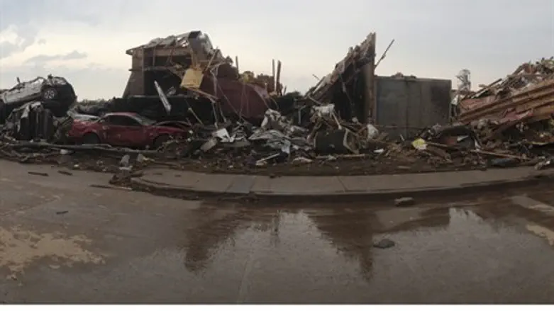 Destroyed buildings and overturned cars after