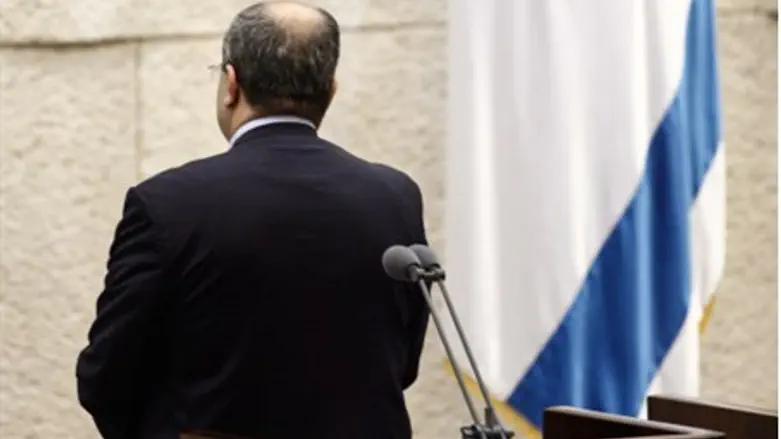 MK Tibi stands with back to Knesset