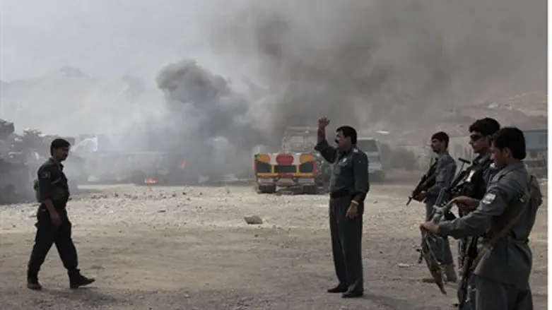 Smoke rises from burning NATO supply trucks