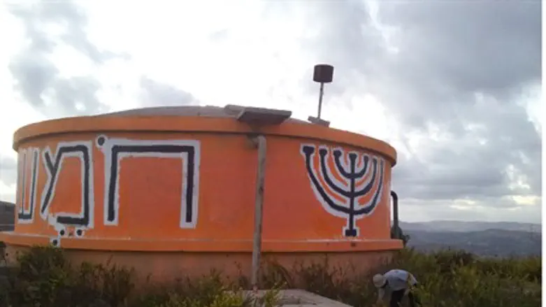 The repainted water tower at Homesh