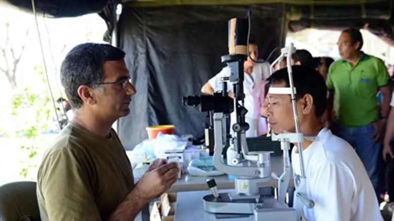 IDF rescue worker examines a patient in the P