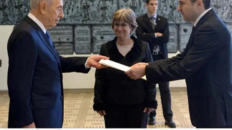  Serbian ambassador Milutin Stanojevic hands 