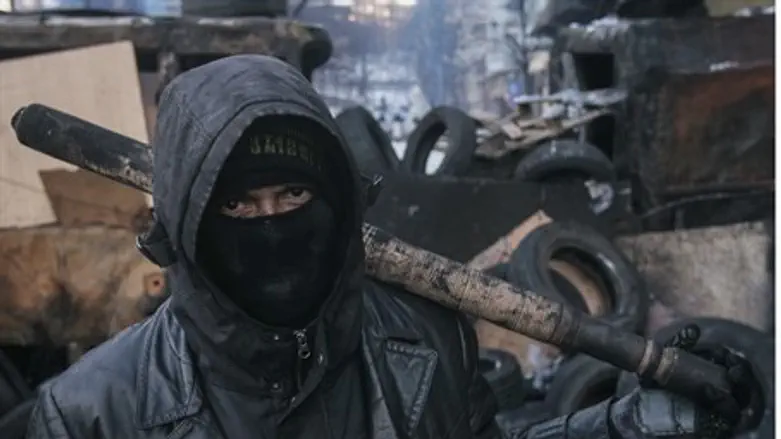 Ukrainian opposition activist wields a baseba
