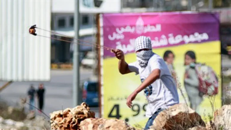 Palestinian Arab terrorist hurling a stone