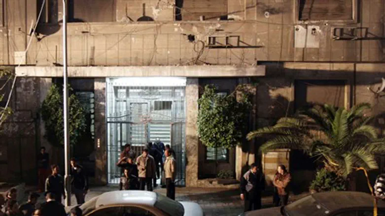 Investigators gather in front of the Israeli 