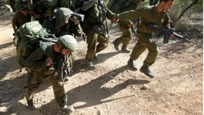 Soldiers carry stretcher in training.