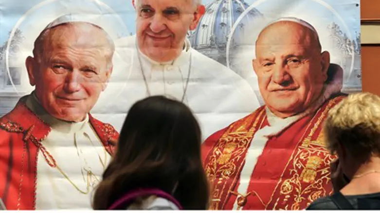 Poster depicting Pope John Paul II (L), Pope