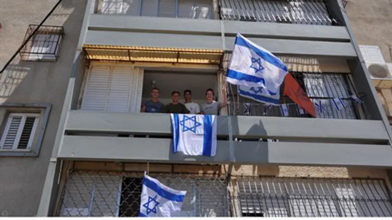 Flags fly in Lod