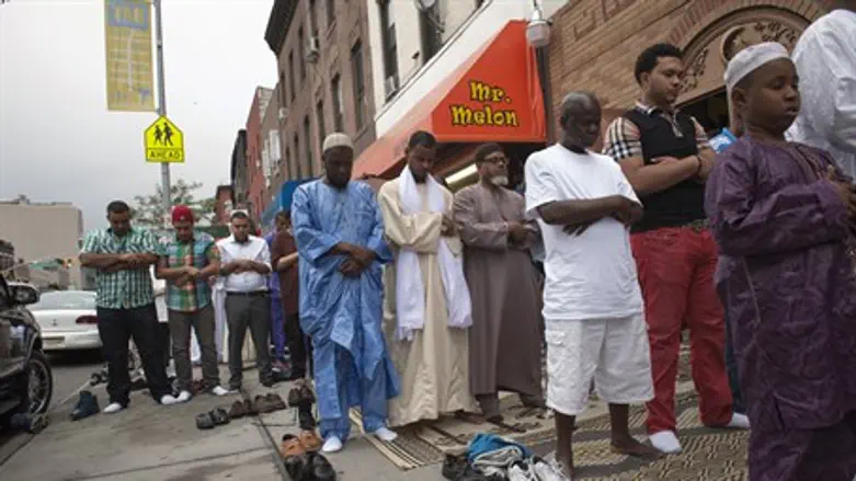 Muslim men pray outside a mosque in Brooklyn,