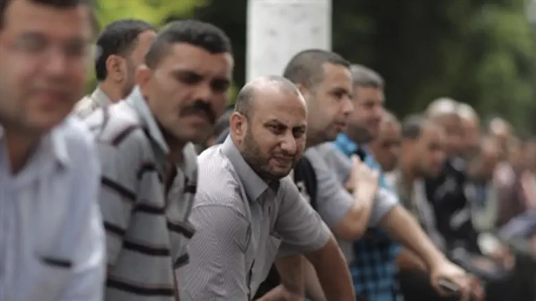 PA employees wait outside closed Gaza bank