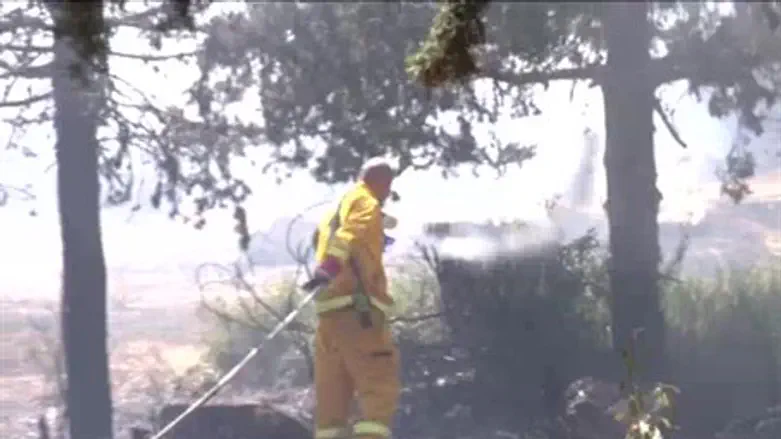 A firefighter battles THursday's boaze