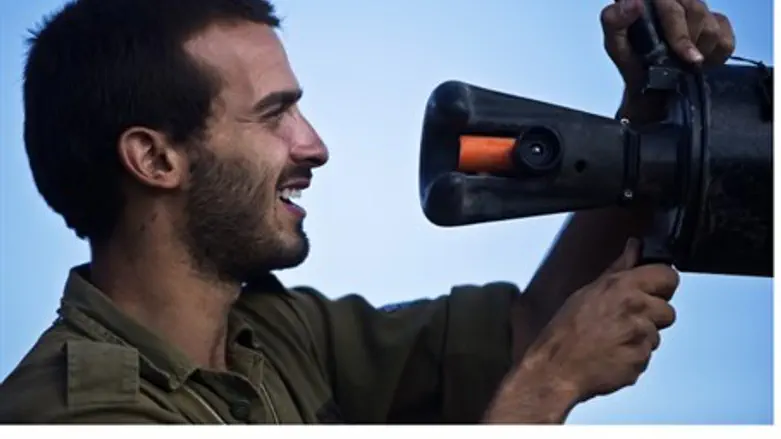 Soldier inspects tank gun barrel