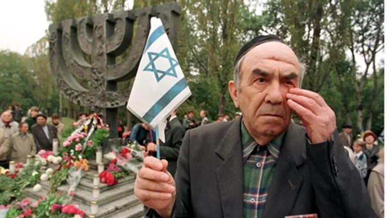 A Babi Yar survivor wipes a tear at a memoria