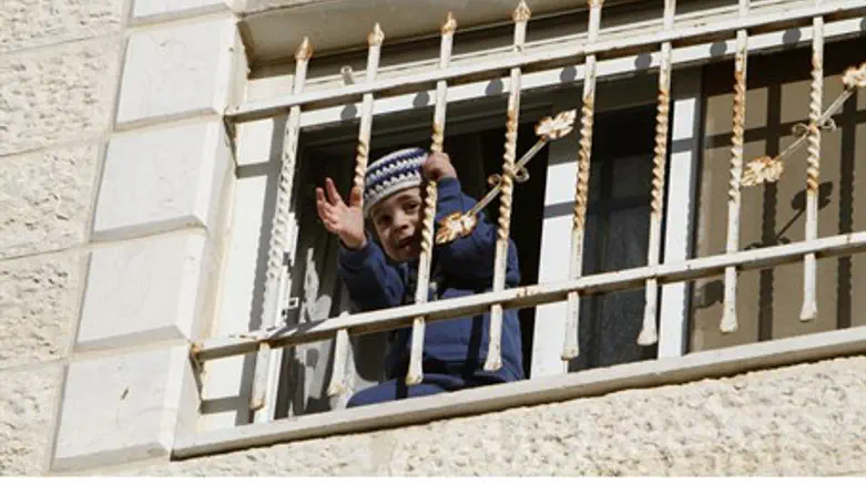 Jewish child peeks from a window in Beit Yeho