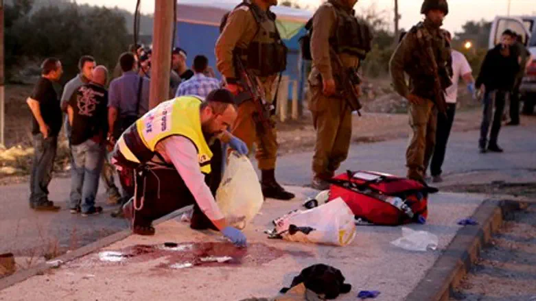 Emergency worker clears blood from the scene 