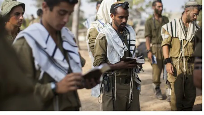 IDF soldiers pray near Gaza