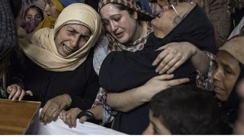 Women grieve over coffin of 15-year-old victim of Taliban school massacre in Pakistan