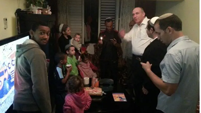 Members of the Garin Torani community light candles in Lod