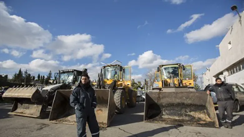 Municipal workers prepare snow plows in Jerusalem