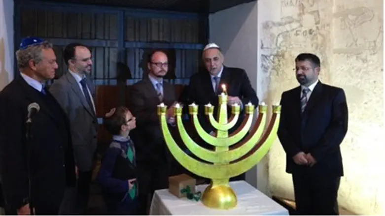 Rav Pinhas (center, with glasses), leads Hanukkah service in Palermo