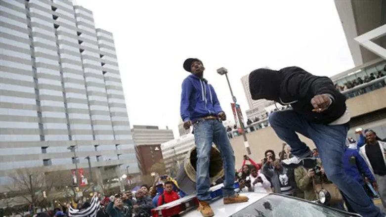 Justified anger? Rioters destroy a pollice car in Baltimore