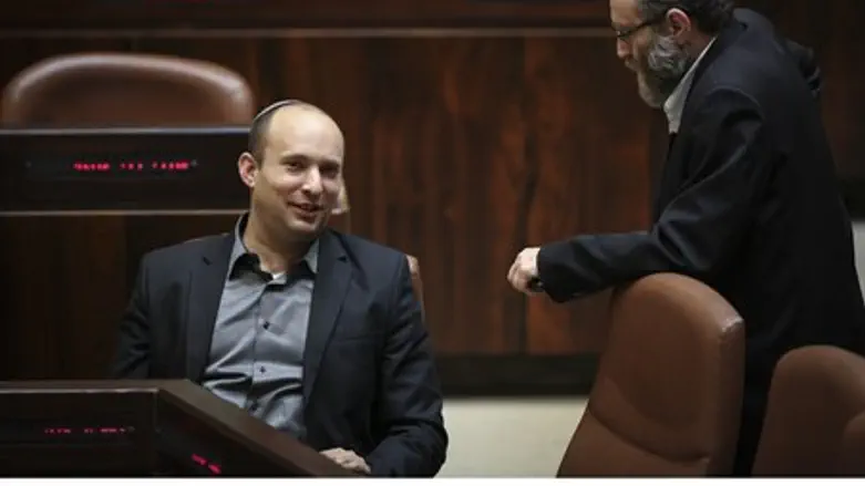 Naftali Bennett speaks to UTJ MK Moshe Gafni after signing coalition deal