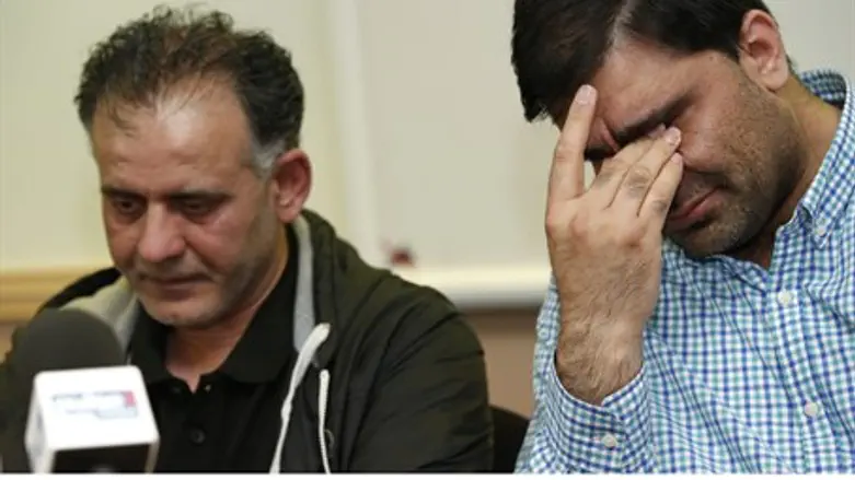 Fathers Akhtar Iqbal and Mohammed Shoaib react during press conference