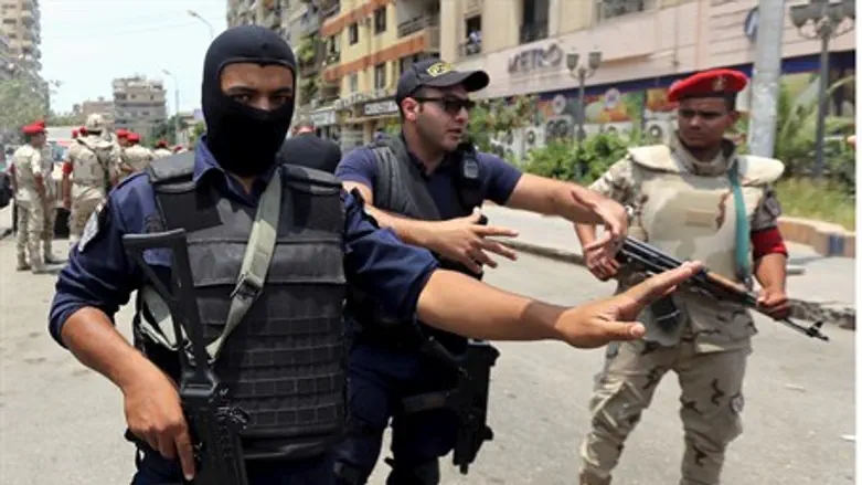 Egyptian security personnel at the site of ISIS car bomb in Cairo
