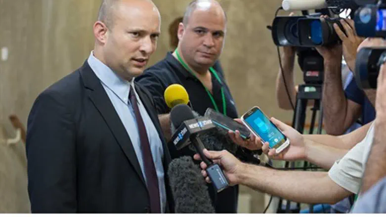 Naftali Bennett speaks to reporters