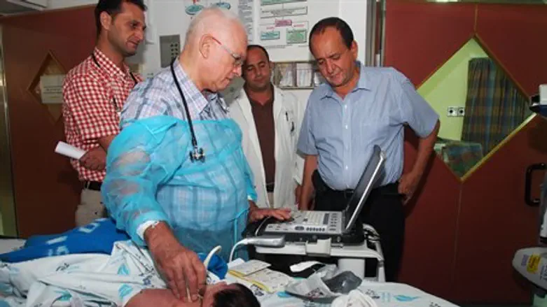 Drs Tamir and Houri examine nine day old baby from Gaza