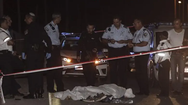 Security forces with terrorist's body at stabbing scene