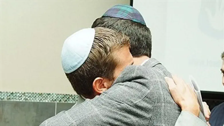 JCW head and abuse survivor Meyer Seewald embraces a relative during the event