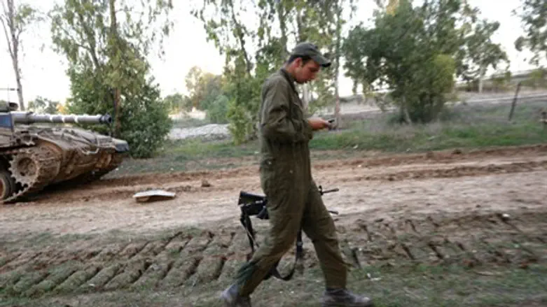 IDF soldier checking cell phone (illustration)