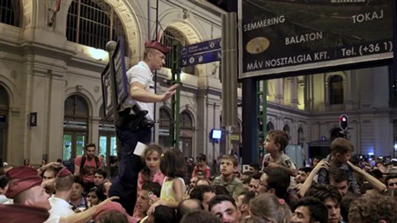 Refugees inundate a train station in Budapest