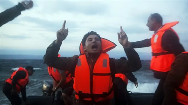 Migrants celebrate upon arriving in Europe