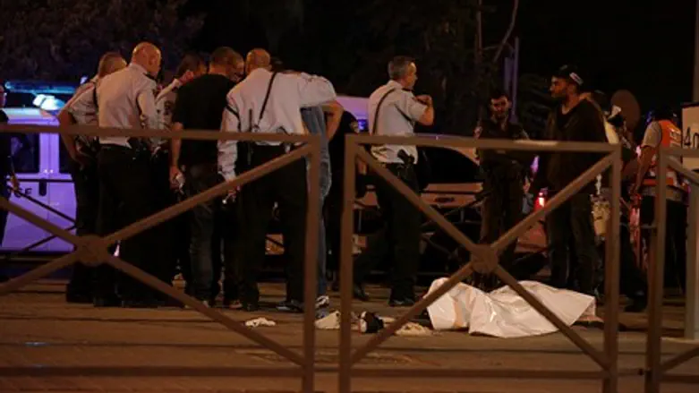 Israeli police standing near the body of a Palestinian terrorist