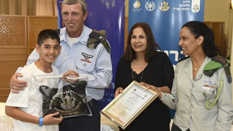 IDF Chief Rabbi Rafi Peretz hands Bar Mitzvah his first pair of tefillin