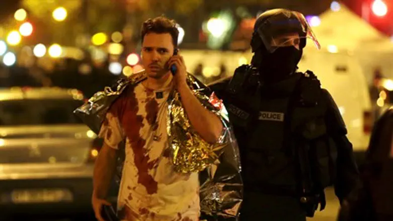 Police with victim outside Bataclan Theater in Paris