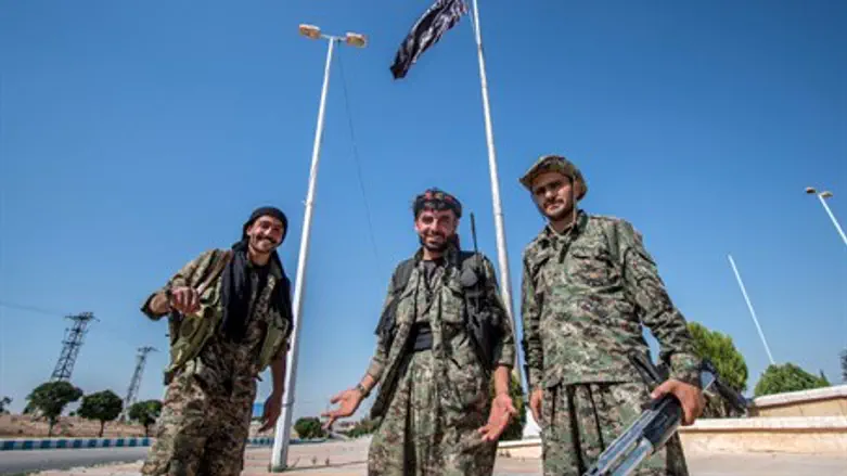Kurdish fighters in town after capturing it from ISIS (illustration)