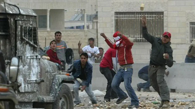 Arab rioter throws bottle