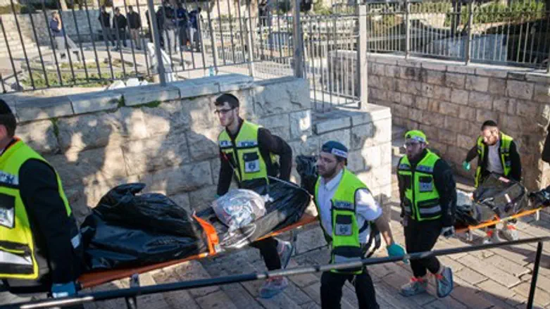 Волонтёры ZAKA уносят тела террористов