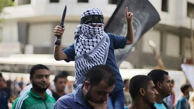 Arab child waves knife during Gaza City march