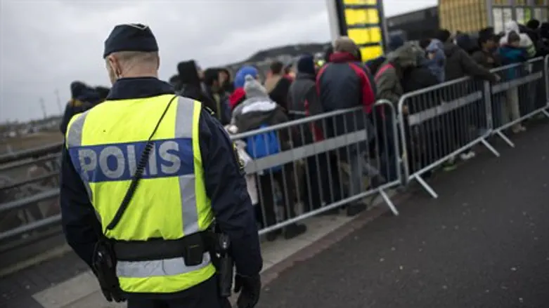 Police guard a group of Muslim migrant in Malmo, Sweden