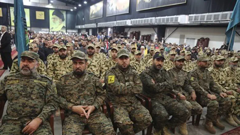 Hezbollah terrorists listen to their leader Hassan Nasrallah