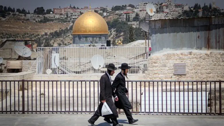 Haredi Jews walk close to the Temple Mount in Jerusalem