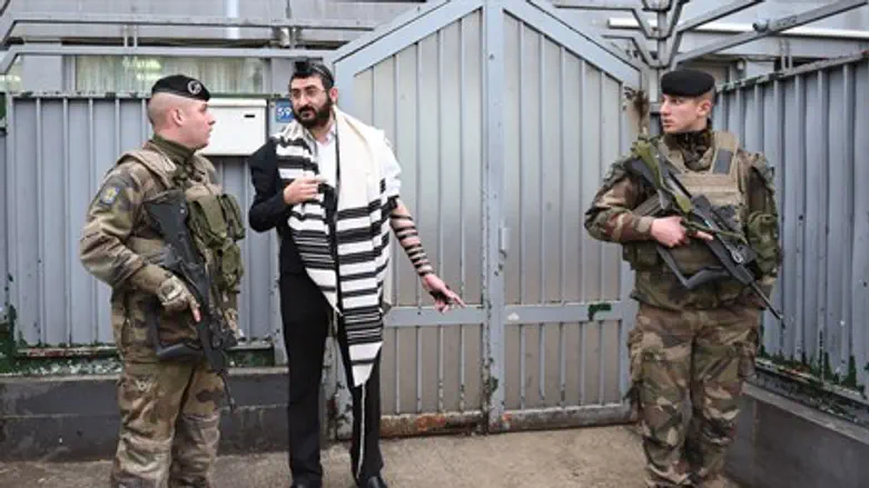 Soldiers guarding a staff member at a Chabad school in Paris, Nov. 16, 2015.