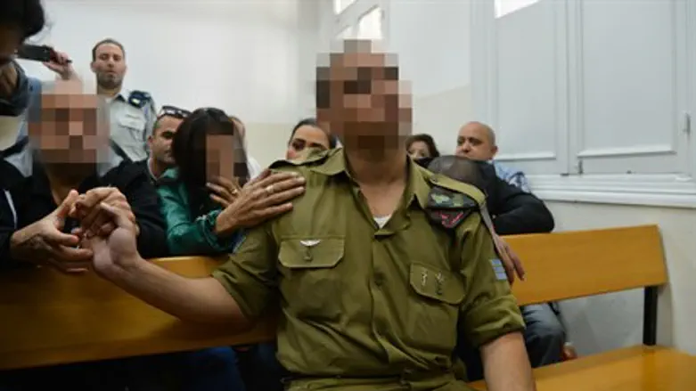 Soldier in court flanked by relatives