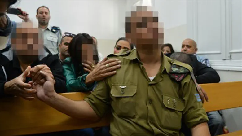 Soldier in court flanked by relatives