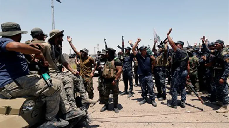 Anti-ISIS forces celebrate in Iraq after taking jihadist position