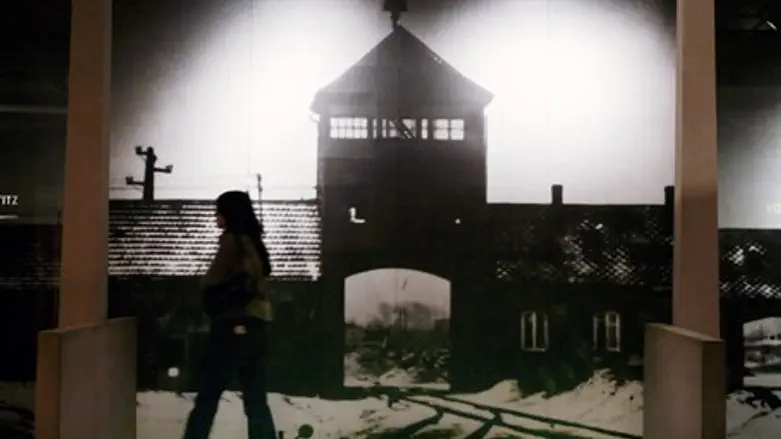 Visitor walks past display at US Holocaust Memorial Museum